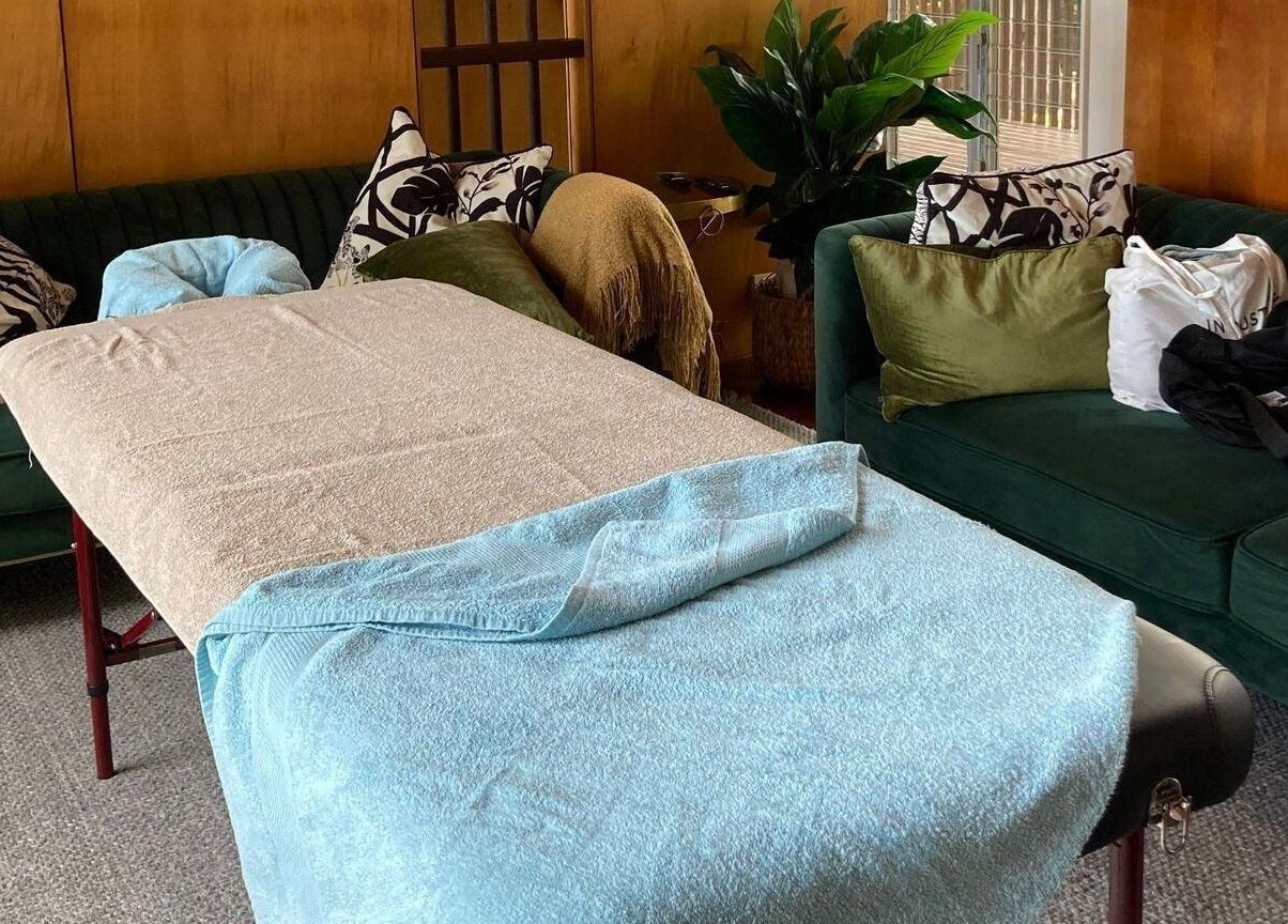 Relaxing massage table setup at Reflect Mobile Spa Agnes Water, Agnes Water, Queensland, AU with plush sofas.