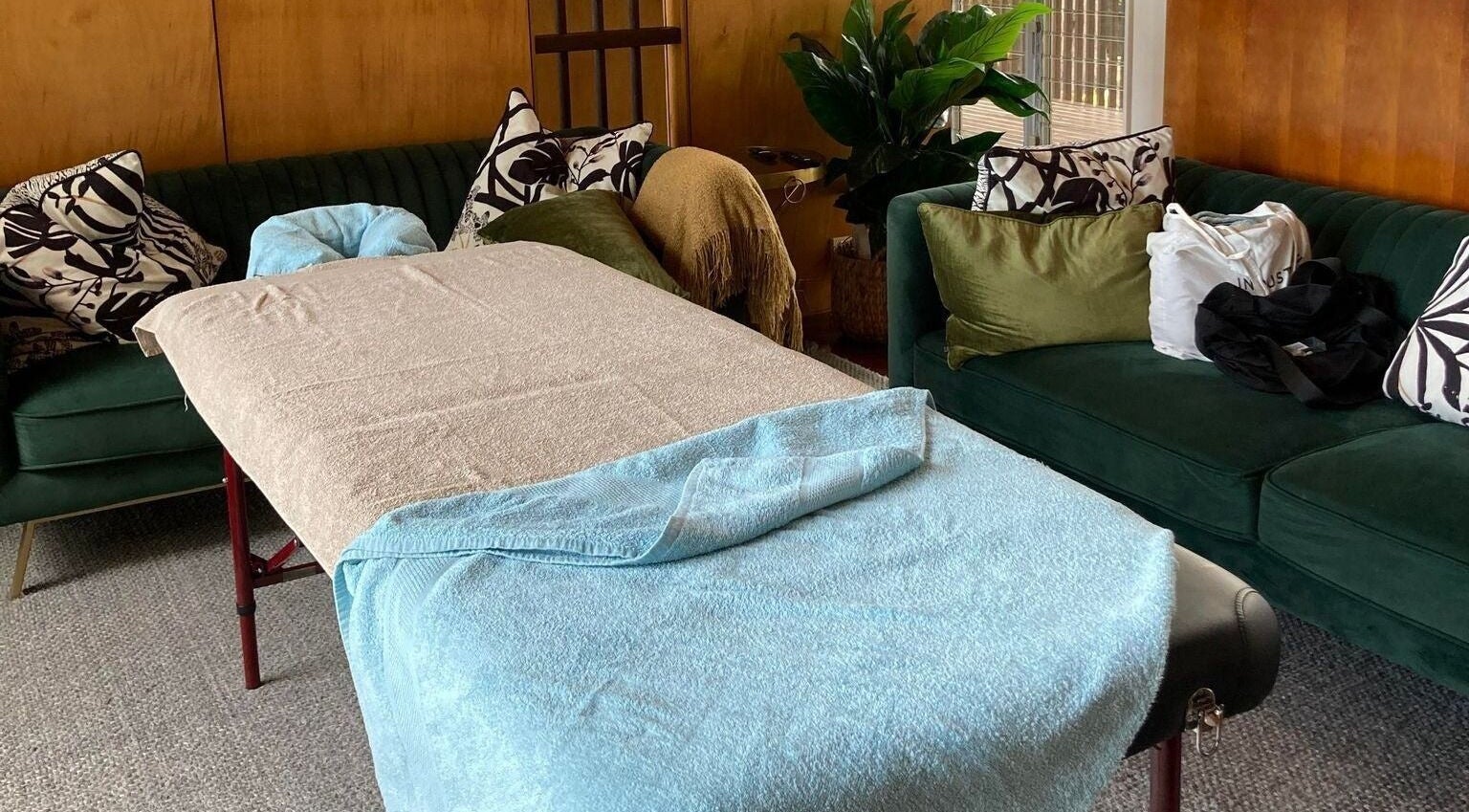 Relaxing massage table setup at Reflect Mobile Spa Agnes Water, Agnes Water, Queensland, AU with plush sofas.