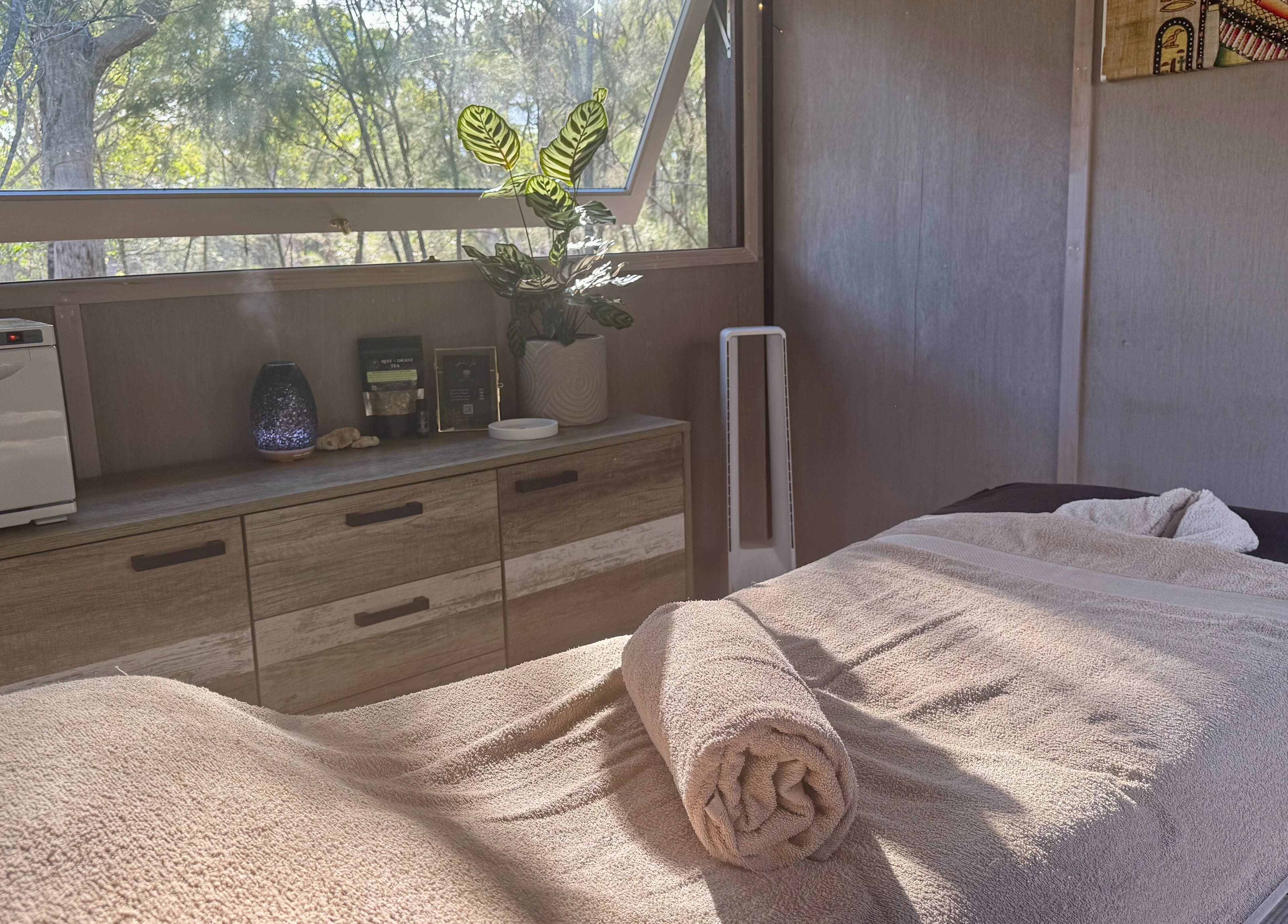 Relaxing treatment room at Reflect Mobile Spa Agnes Water in Queensland, AU, showcasing natural light and calming decor.