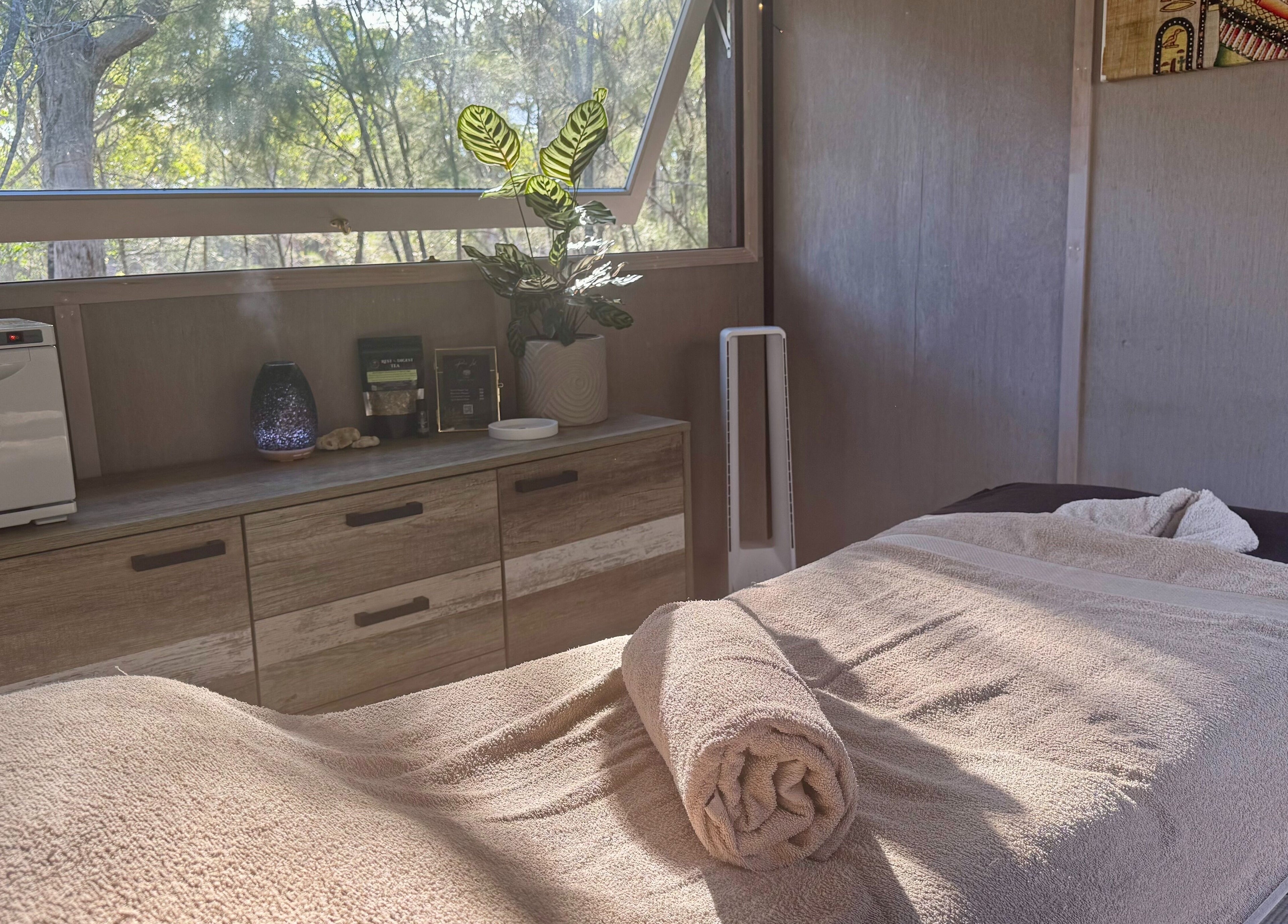Relaxing treatment room at Reflect Mobile Spa Agnes Water in Queensland, AU, showcasing natural light and calming decor.