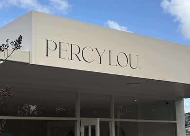 Elegant facade of Hair by Bec de Bruin, Newtown, Victoria with blue sky background.