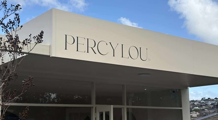 Elegant facade of Hair by Bec de Bruin, Newtown, Victoria with blue sky background.