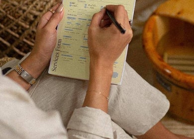 Close-up of a client filling out a services form at Le Senes Spa, Riyadh, Riyadh Province, SA.