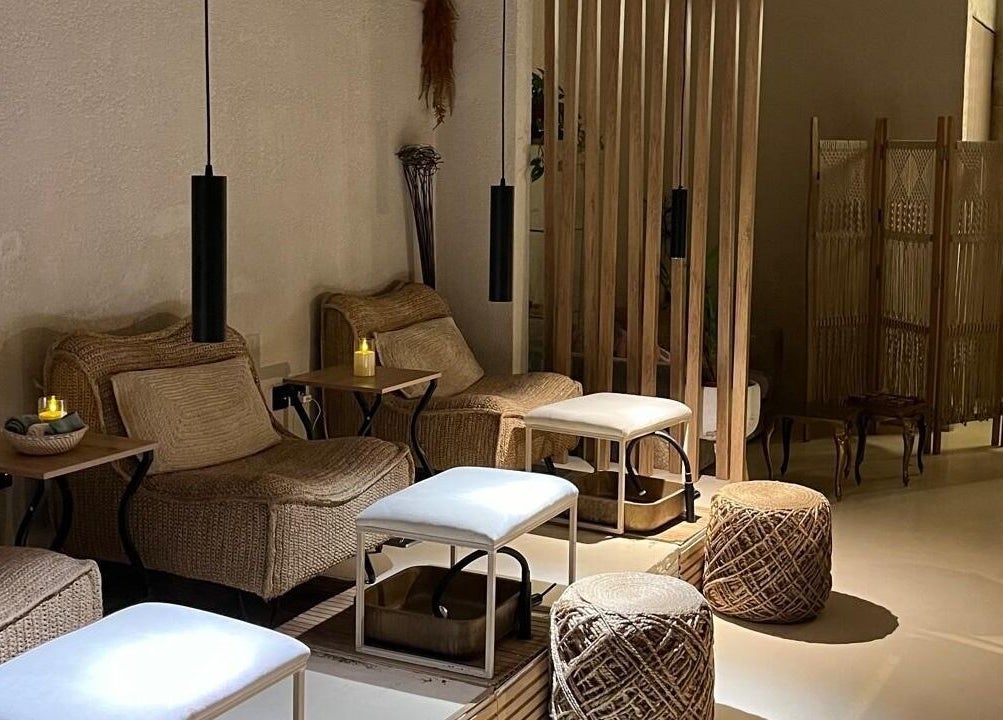 Relaxing seating area at Le Senes Spa, Riyadh, Riyadh Province, SA with wicker chairs and soft lighting.