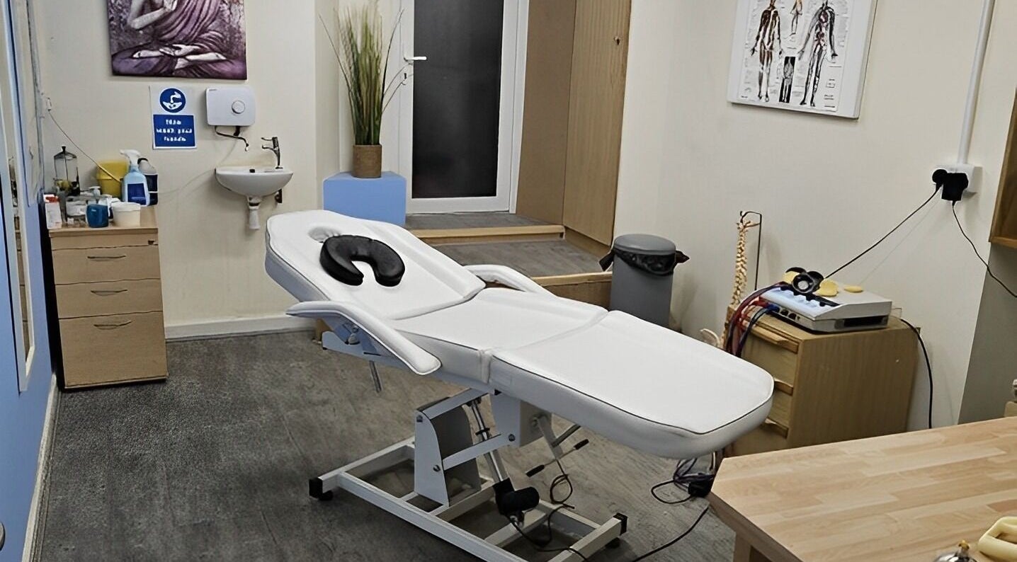 Modern massage room at Pro Flex Health, Plymouth, England, GB featuring massage table and soothing decor.