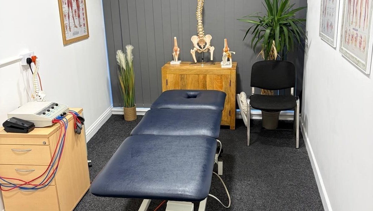 Pro Flex Health therapy room in Plymouth, England, GB, featuring a massage table and anatomical decor.