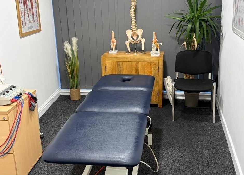 Pro Flex Health therapy room in Plymouth, England, GB, featuring a massage table and anatomical decor.