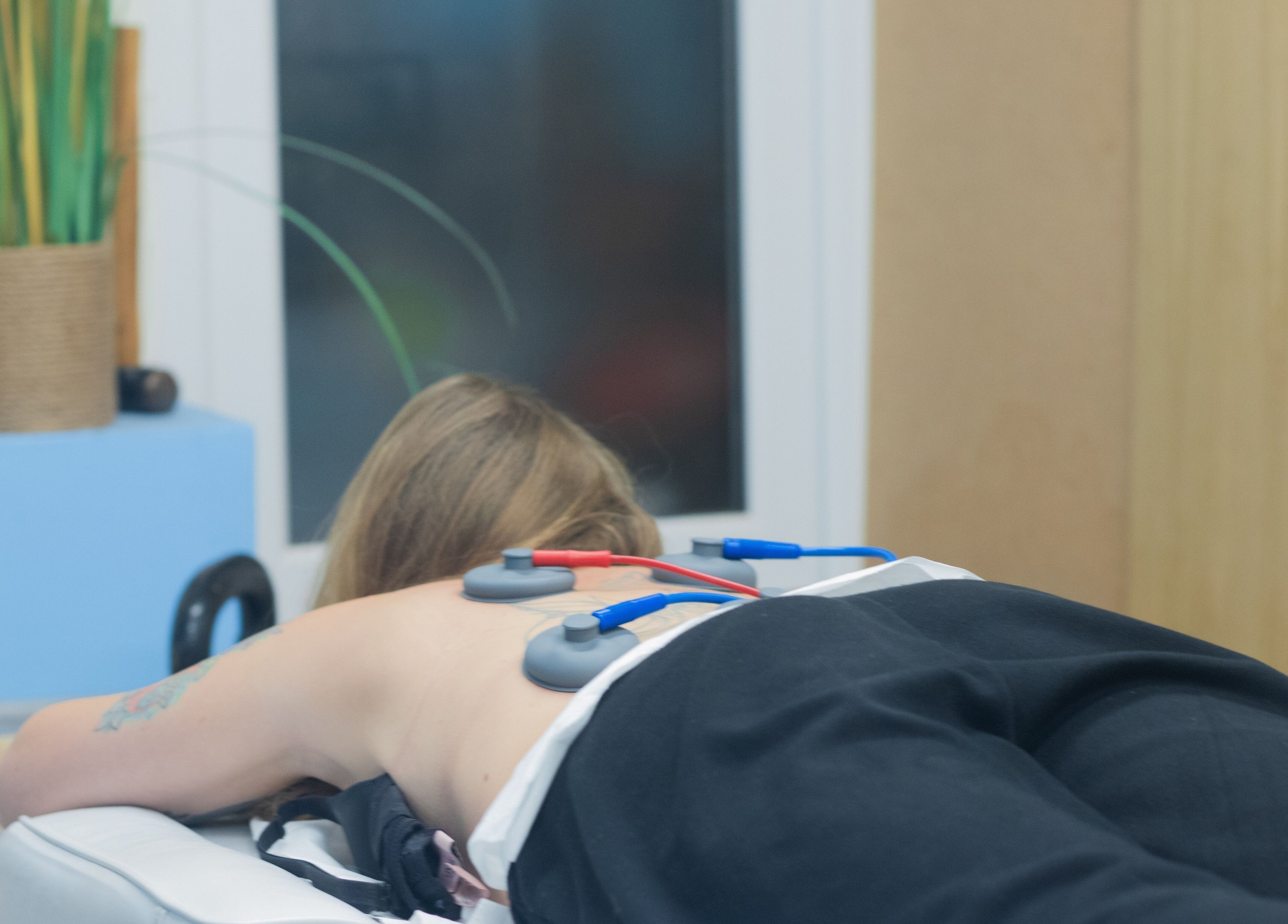 Person receiving electrotherapy treatment at Pro Flex Health, Plymouth, England, GB for muscle relaxation.