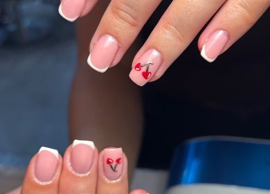 Close-up of cherry nail art at Beauty By Meg, Bridlington, England, GB, showcasing elegant French tips.