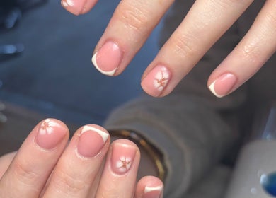Elegant nail art with pink polish and flower design at Beauty By Meg, Bridlington, England, GB.