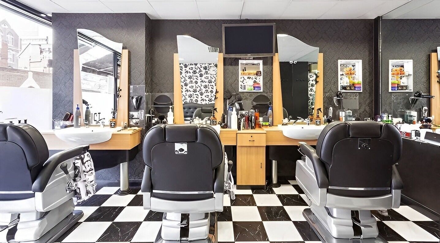 Elegant interior of Dani’s Barber Shop in London, England, GB featuring sleek chairs and modern decor.