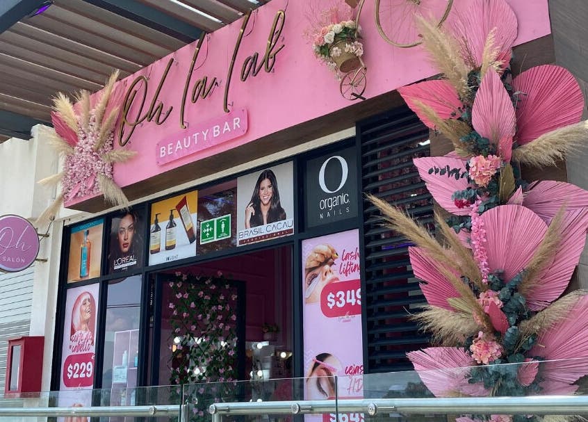 Fachada de Oh La Lab en Ojo De Agua, Estado De México, MX, decorada con detalles florales y letrero llamativo.