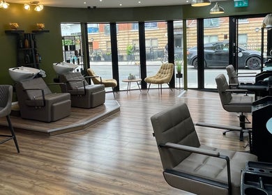 Modern salon interior at Stevostyle Hair Beauty, London, England, GB, with stylish chairs and decor.