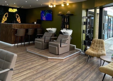 Modern salon interior of Stevostyle Hair Beauty in London, England, GB with stylish chairs and washing stations.