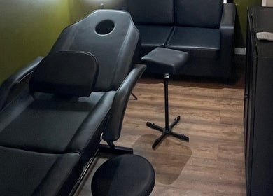 Relaxing treatment room at Stevostyle Hair Beauty, London, England, GB, featuring modern black chair and decor.