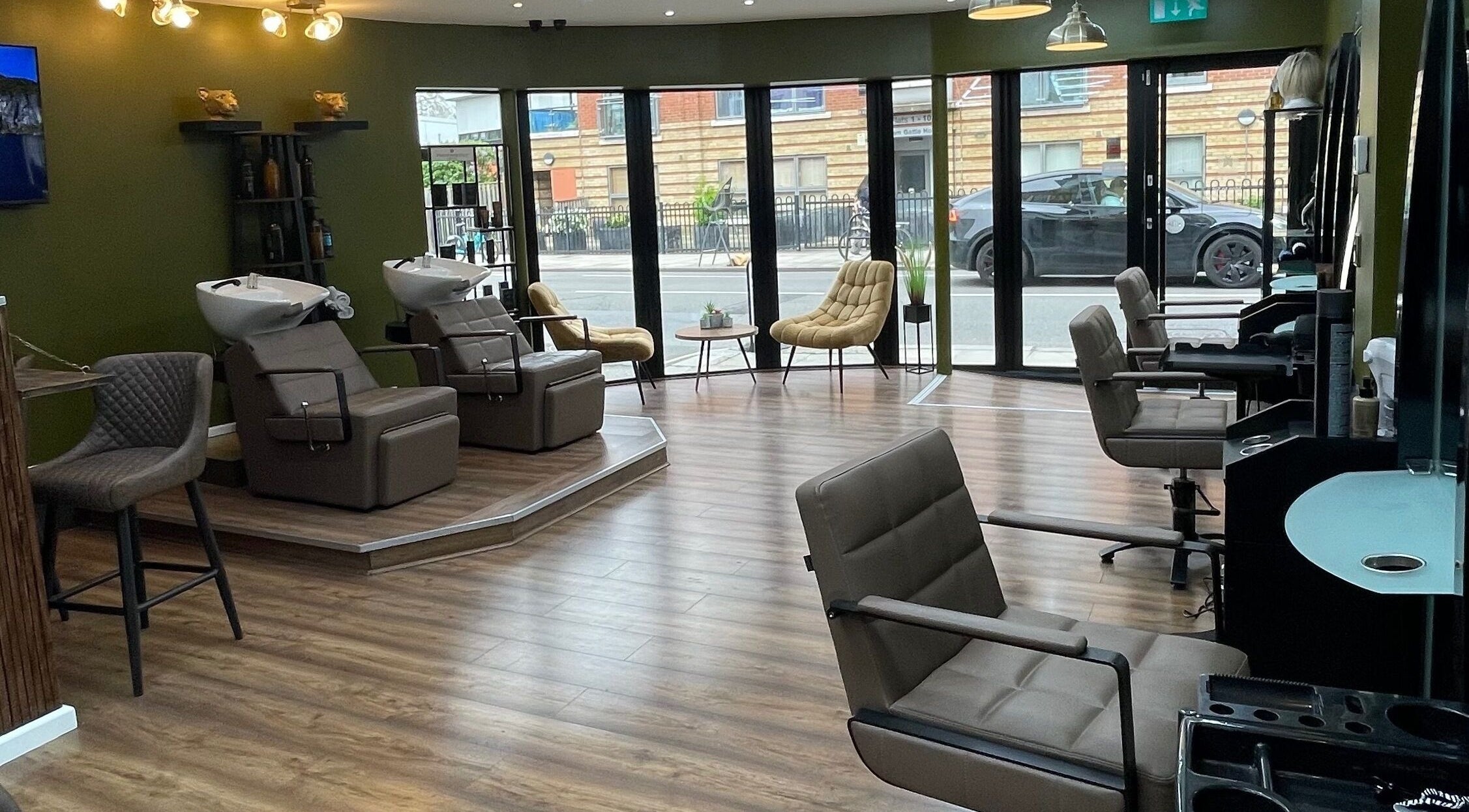 Modern interior of Stevostyle Hair Beauty, London, England, GB, featuring stylish seating and chic decor.