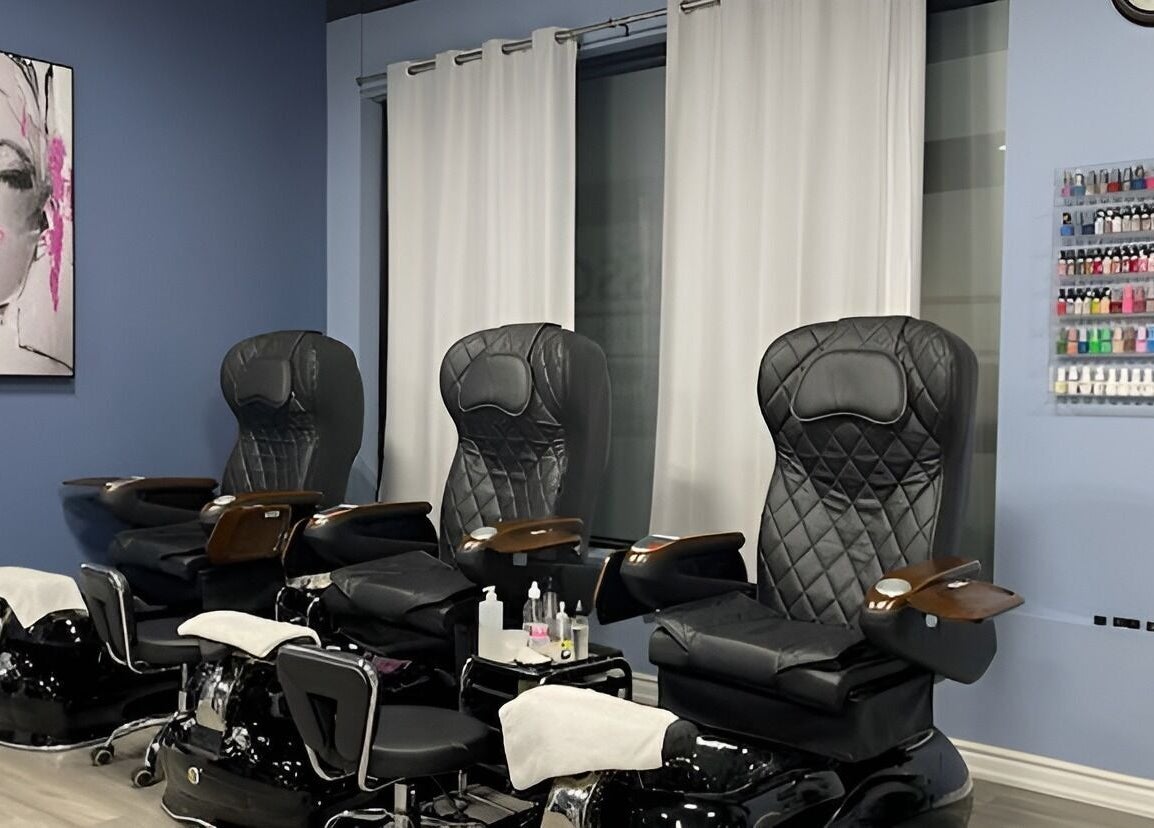 Luxurious pedicure chairs at Luxe Salon & Spa, Brampton, Ontario, CA, featuring modern decor and nail polish display.