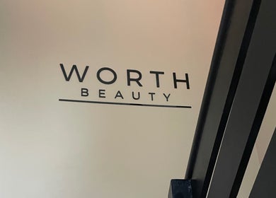 Worth Beauty entrance logo displayed at Cleckheaton, England, GB on a modern wall.