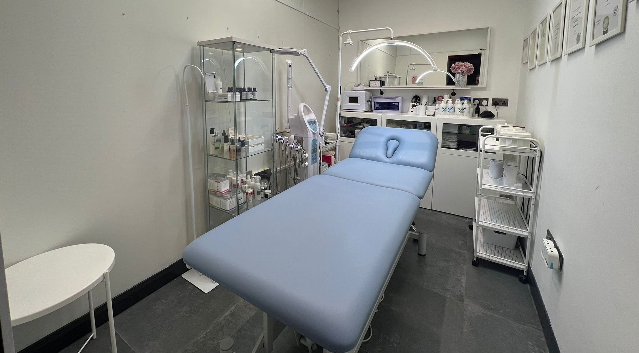 Bright, modern treatment room at SLS Beauty Clinic and Tanning, Chesham, England, GB, featuring a comfy spa bed.