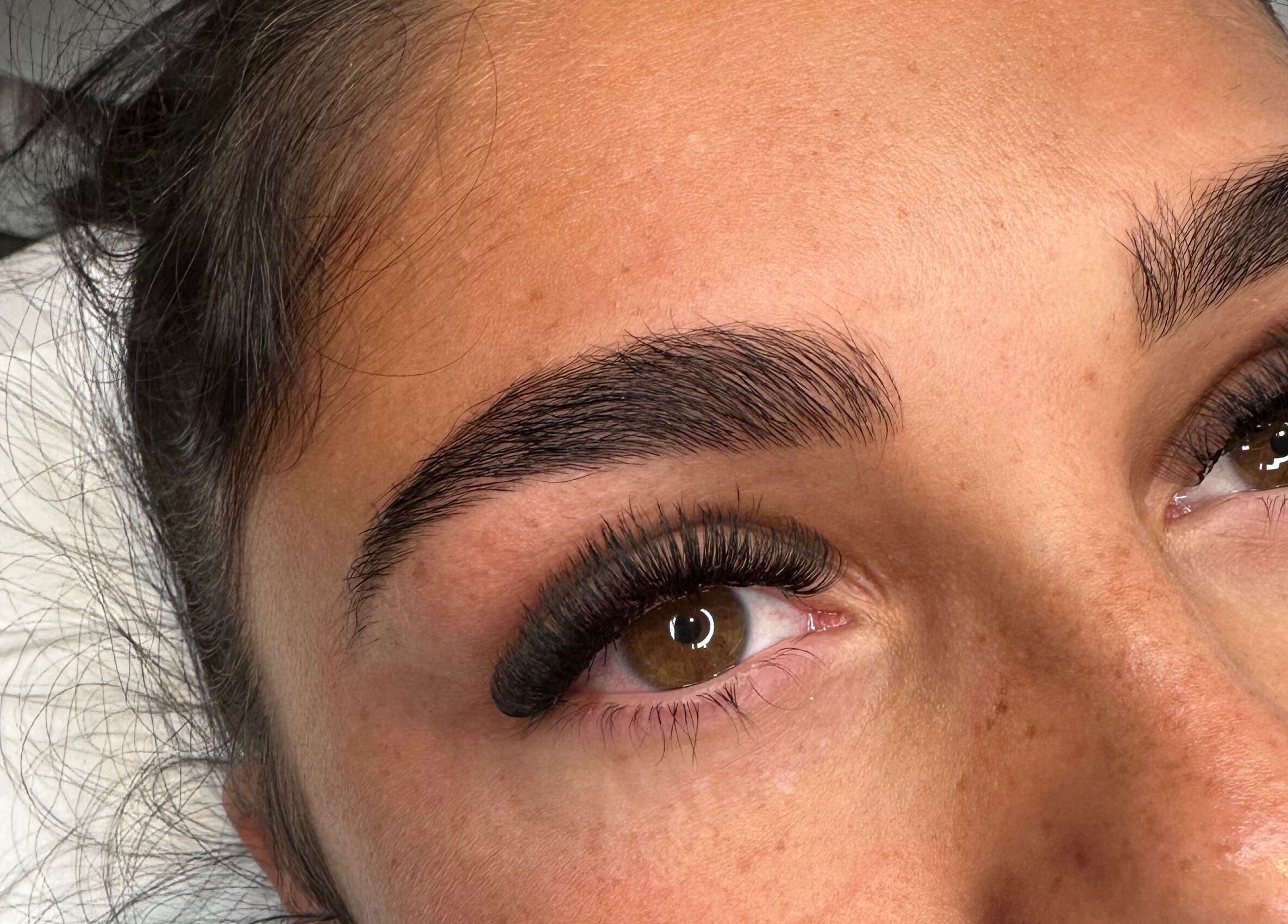 Beautiful eyelash extensions at Lashes by Olivia Niamh in Dartford, England, GB. Perfectly groomed brows complement the look.
