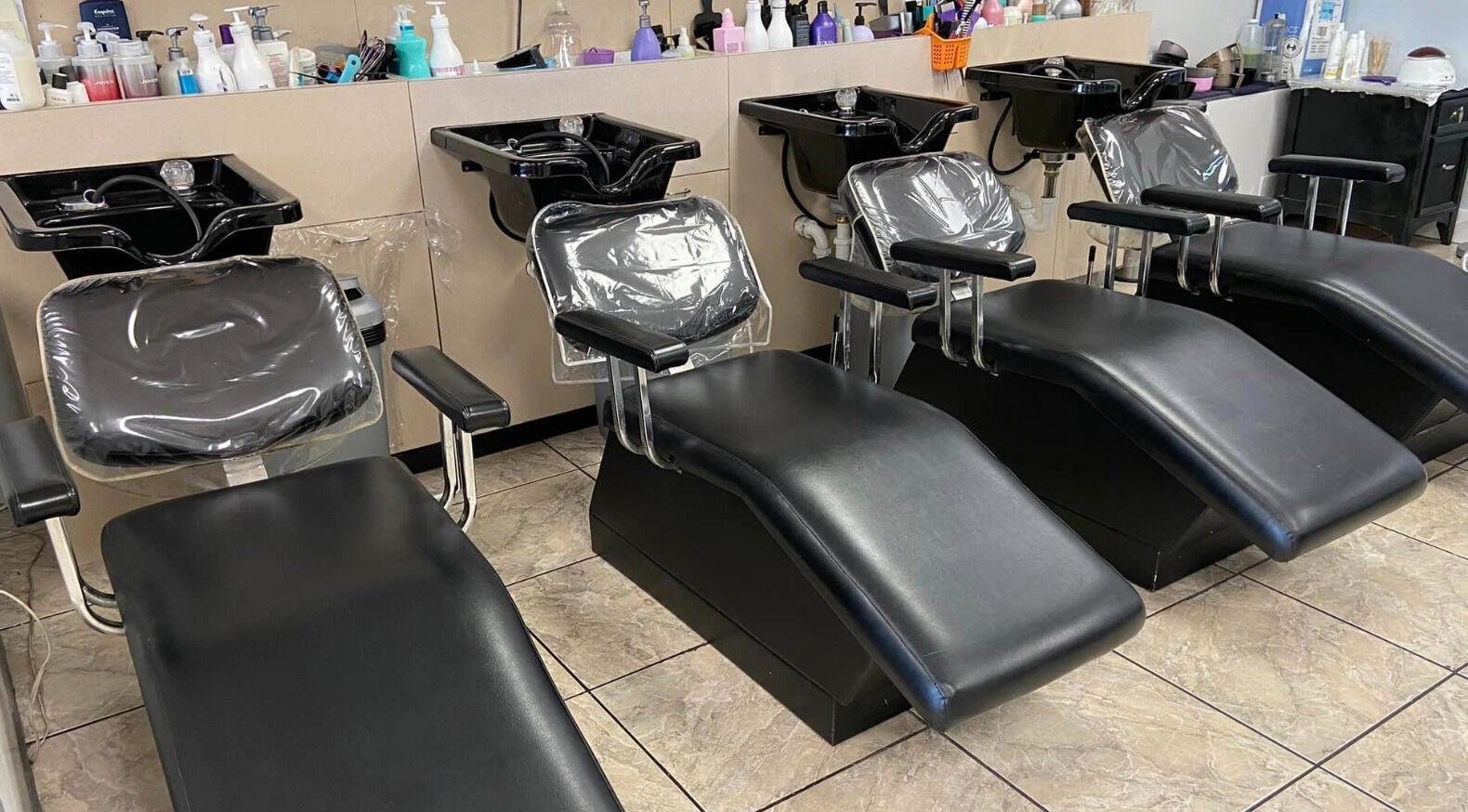 Luxurious shampoo chairs at Cutters Corner, Foley, Alabama, US, ready for a serene hair wash experience.