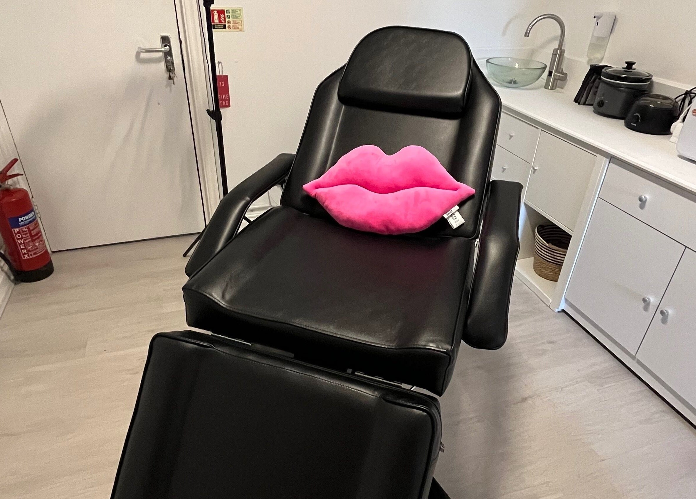 Comfortable beauty chair with pink lips pillow at Bonita Aesthetics and Beauty, Braintree, England, GB.