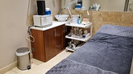 Cozy treatment room at Kudos Beauty (Calla Lily), Kildare, County Kildare, IE. Features a plush bed and essential tools.