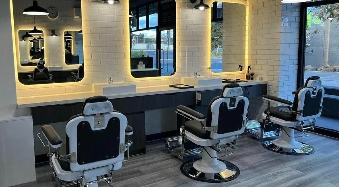 Modern barber chairs in Royal Classic Barber, Melbourne, Victoria, AU with stylish lighting and mirrors.