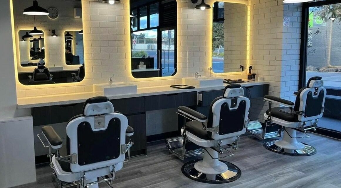 Modern barber chairs in Royal Classic Barber, Melbourne, Victoria, AU with stylish lighting and mirrors.