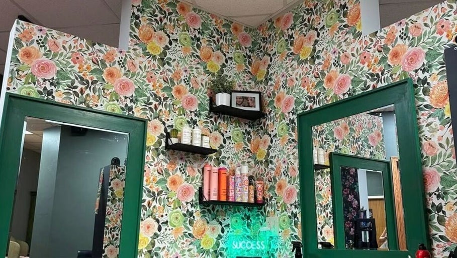 Chic floral walls at Styles By Margarita, Green Bay, Wisconsin, US with stylish shelves and mirrors.
