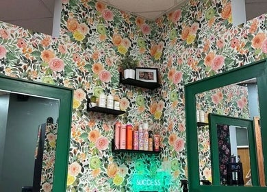 Chic floral walls at Styles By Margarita, Green Bay, Wisconsin, US with stylish shelves and mirrors.