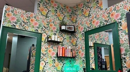 Chic floral walls at Styles By Margarita, Green Bay, Wisconsin, US with stylish shelves and mirrors.