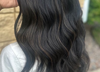 Elegant dark wavy hairstyle at Styles By Margarita, Green Bay, Wisconsin, US.