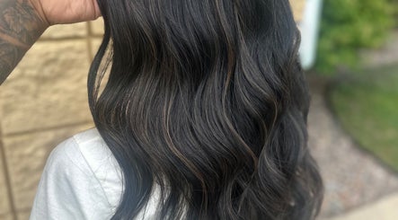 Elegant dark wavy hairstyle at Styles By Margarita, Green Bay, Wisconsin, US.