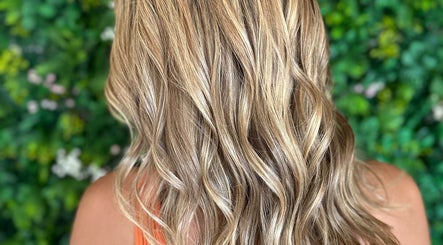 Blonde wavy hair styled at Styles By Margarita, Green Bay, Wisconsin, US with lush natural backdrop.