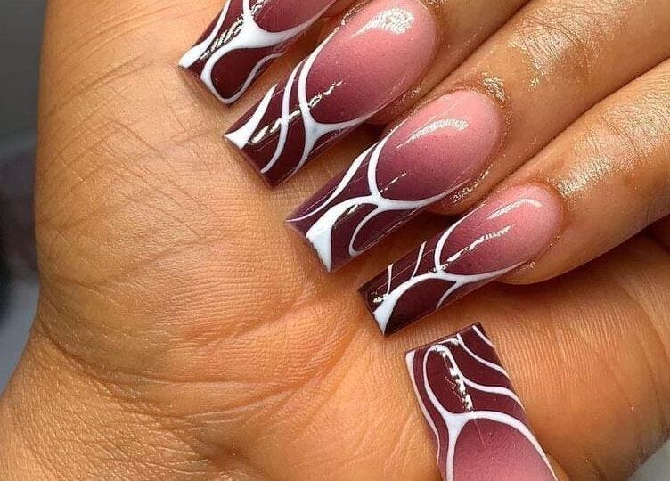 Stylish maroon and white nail art by Nails by Ryan, Jos, Plateau, NG, showcasing intricate design.