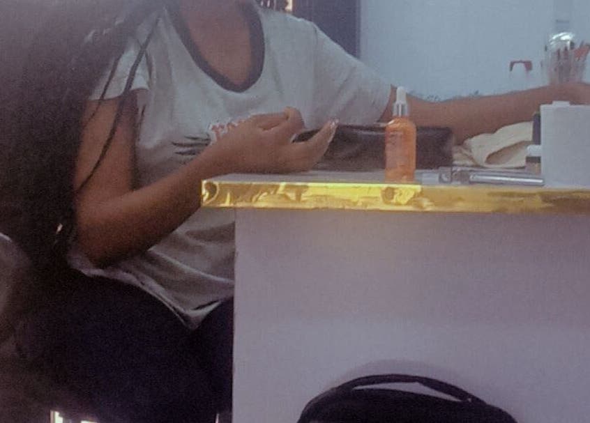 Client receiving manicure at Nails by Ryan, Jos, Plateau, NG. Elegant setup with nail tools visible.