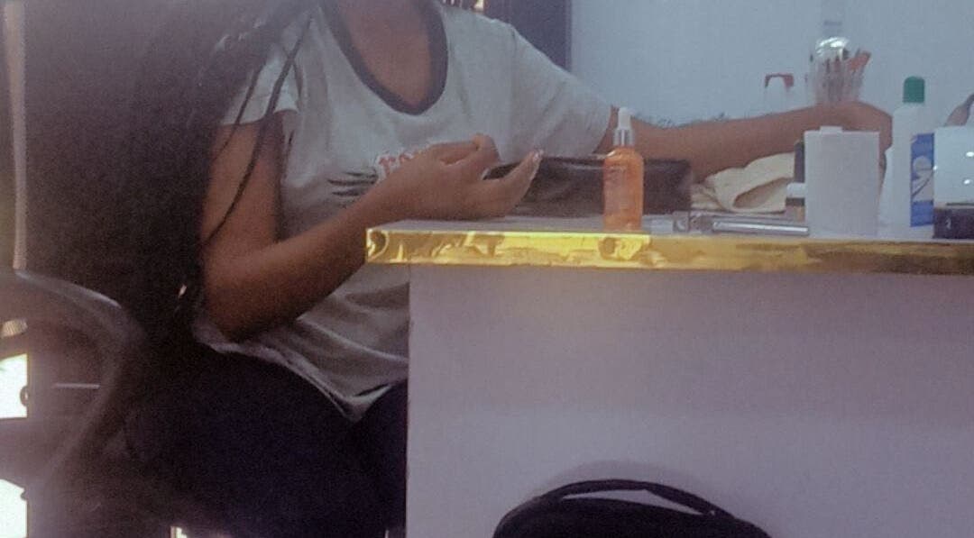 Client receiving manicure at Nails by Ryan, Jos, Plateau, NG. Elegant setup with nail tools visible.