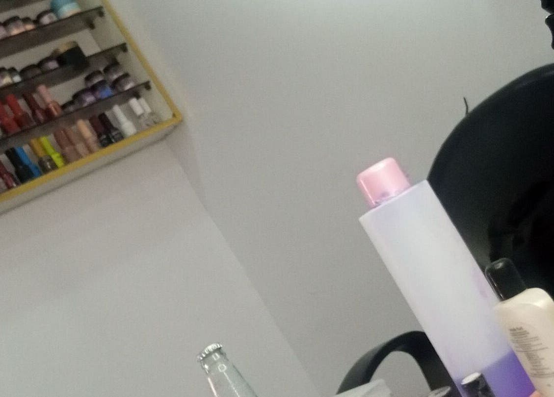 Nail polish shelves at Nails by Ryan, Jos, Plateau, NG, showcasing a vibrant selection for perfect manicures.