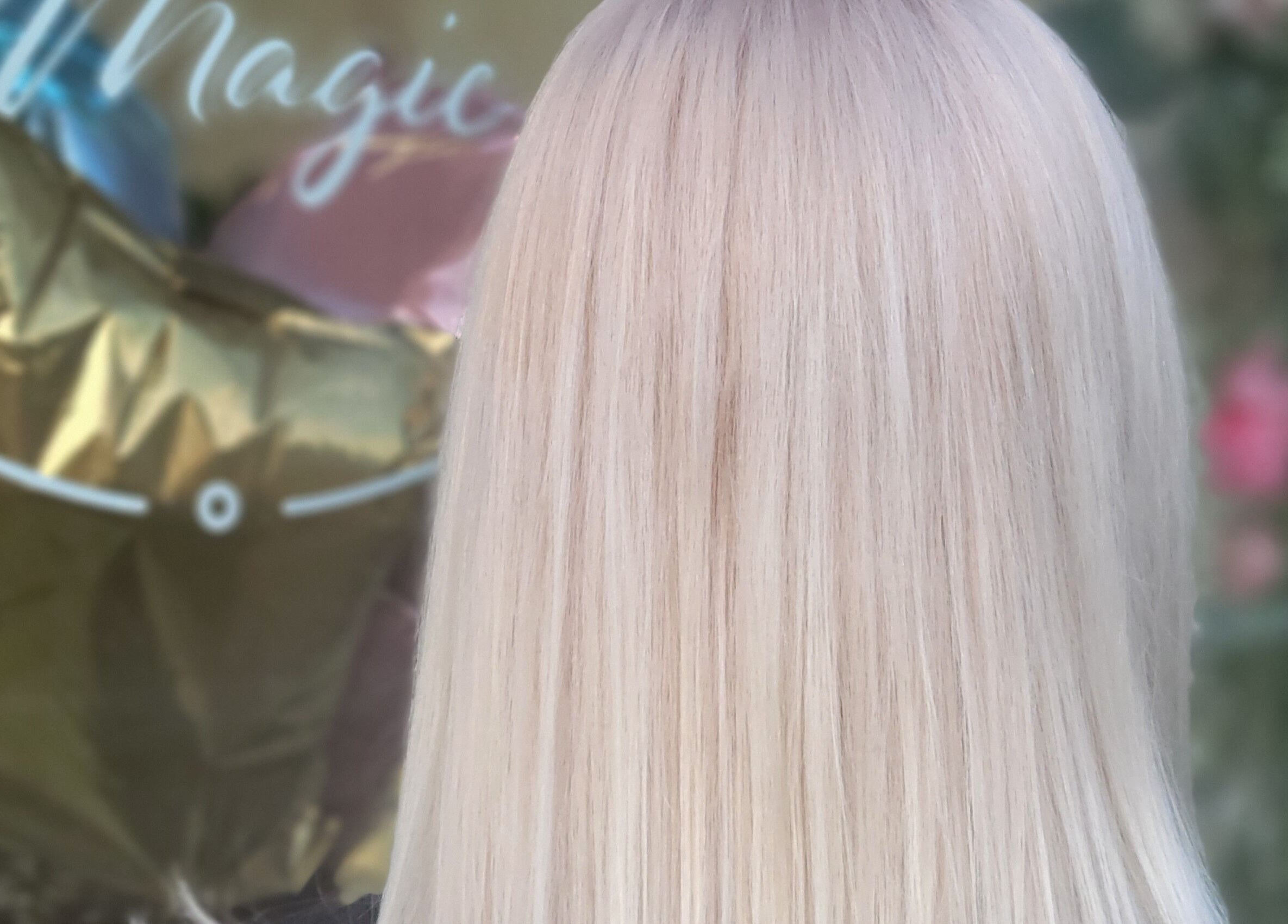 Elegant blonde hairstyle at Practically Magic, South Glens Falls, New York, US, showcasing sleek hair care service.