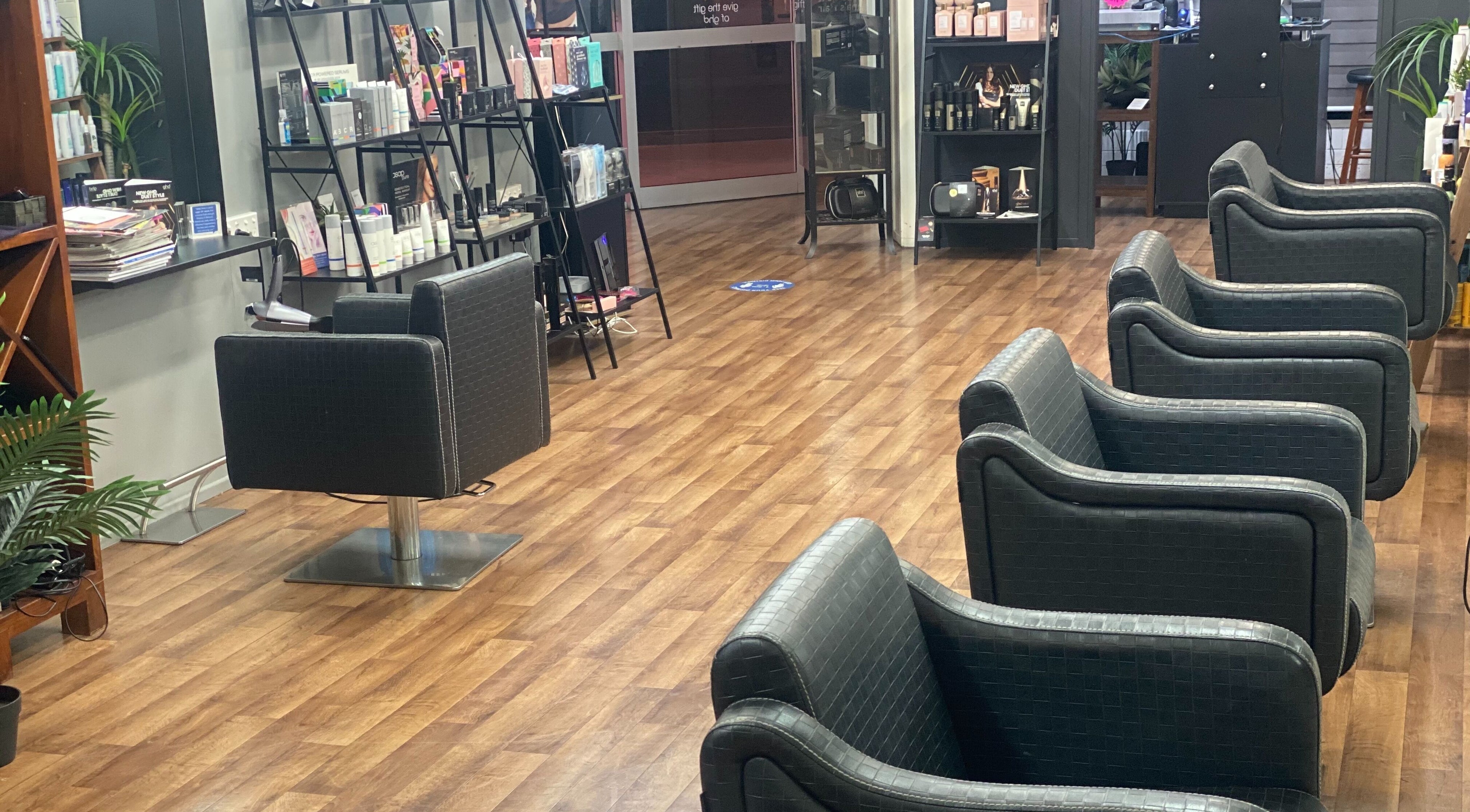 Modern salon interior at Annas Hair, Boonah, Queensland, AU, featuring stylish chairs and product shelves.