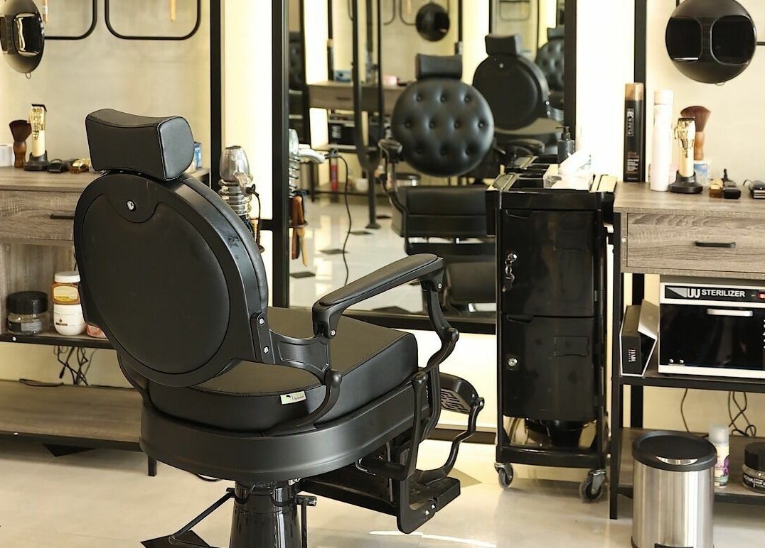 Modern barber chair at Mirror Barbershop, Riyadh, Riyadh Province, SA, showcasing sleek interior style.