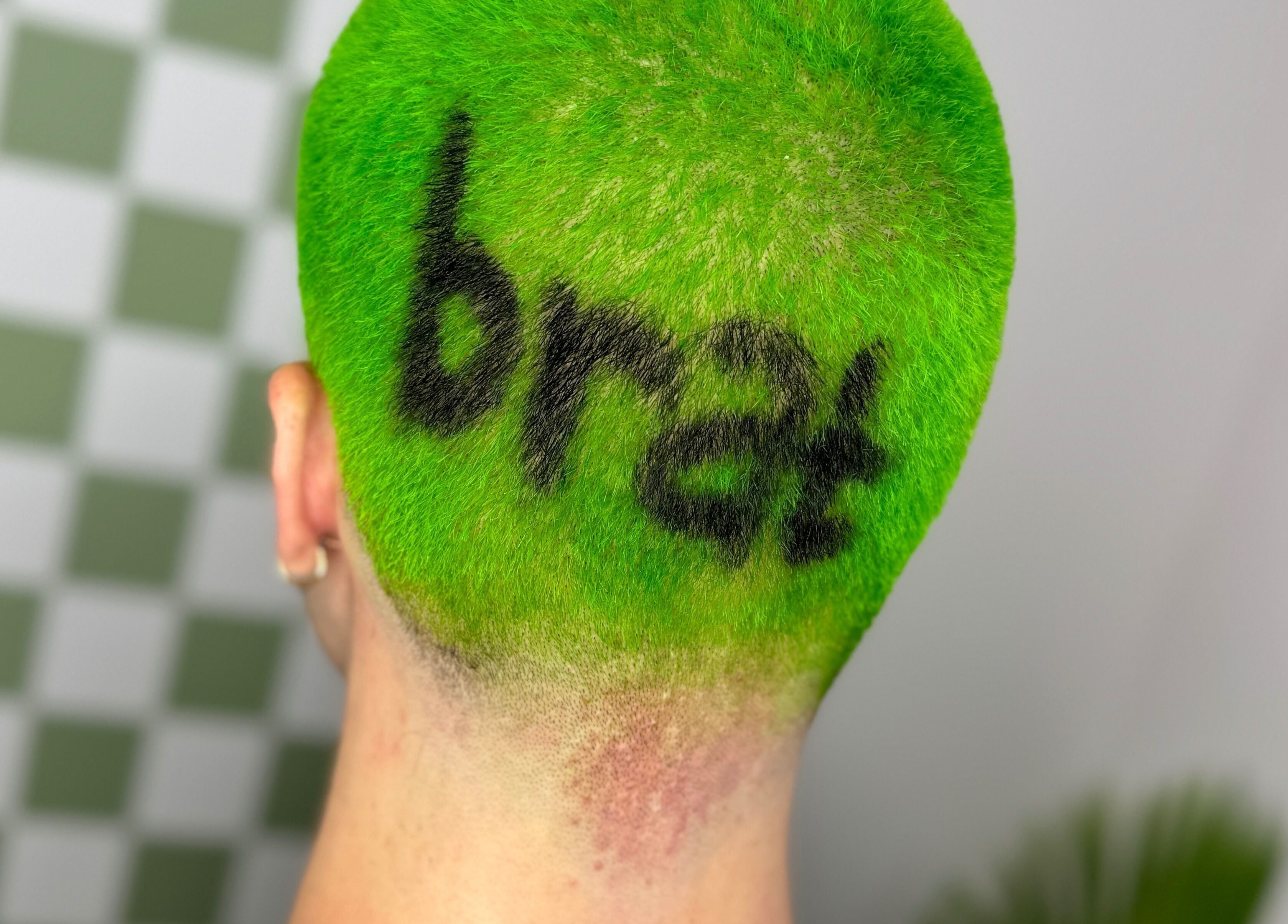 Bold neon green hair with artistic design at Hair Senpai, Campbelltown, New South Wales, AU.