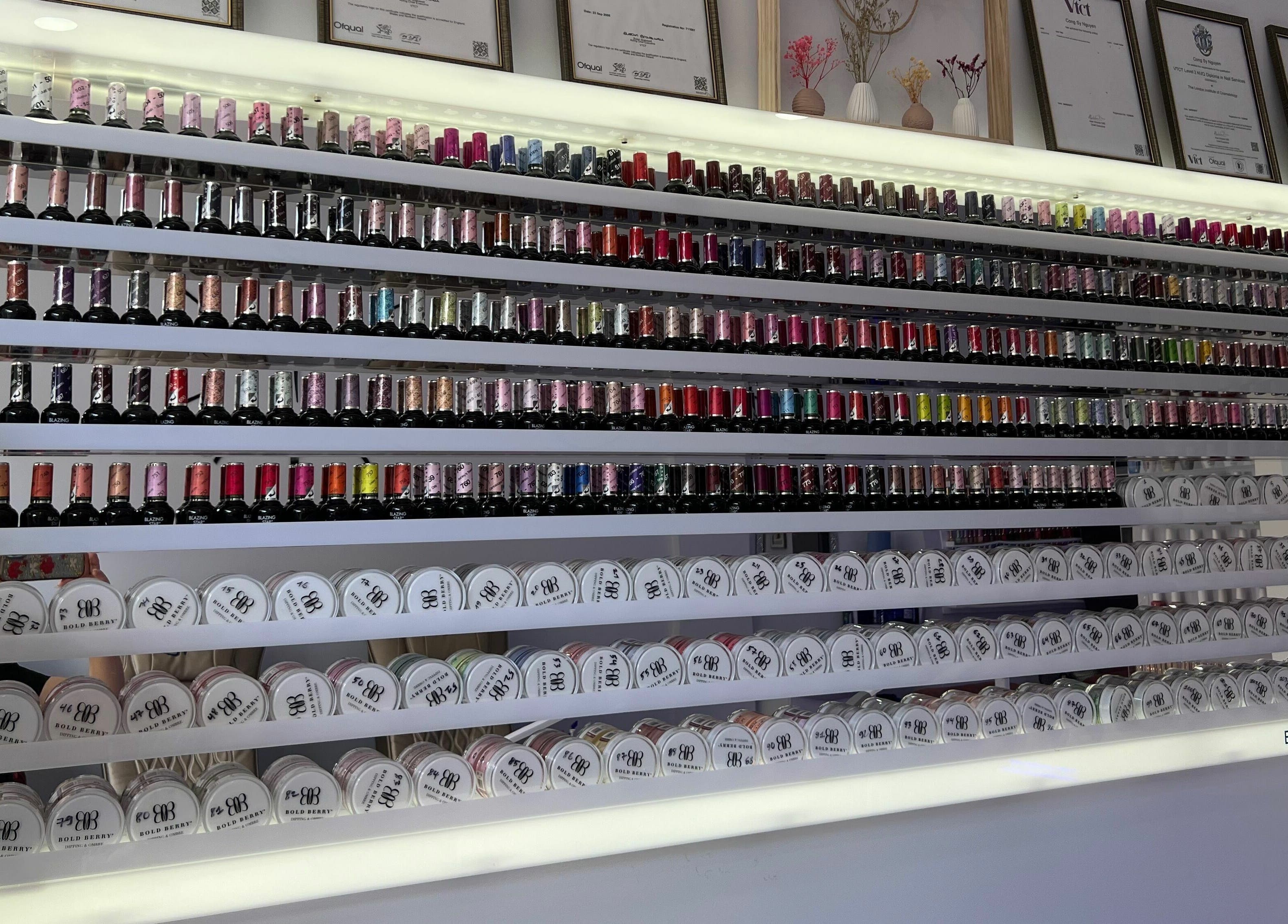Vibrant nail polish display at Q Nail Bar, London, England, GB, showcasing a variety of colors.
