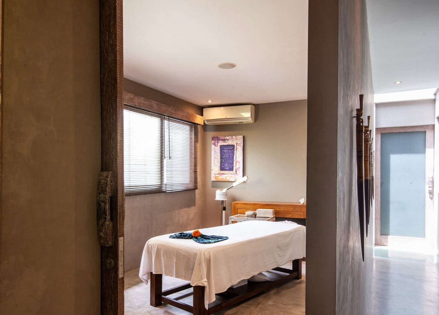 Tranquil therapy room at Mudara Spa, Bali, Bali, ID featuring serene decor and massage table.