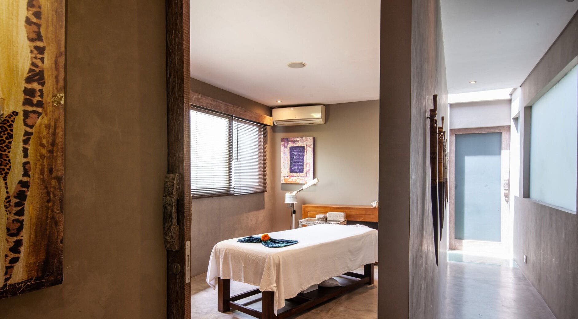 Tranquil therapy room at Mudara Spa, Bali, Bali, ID featuring serene decor and massage table.
