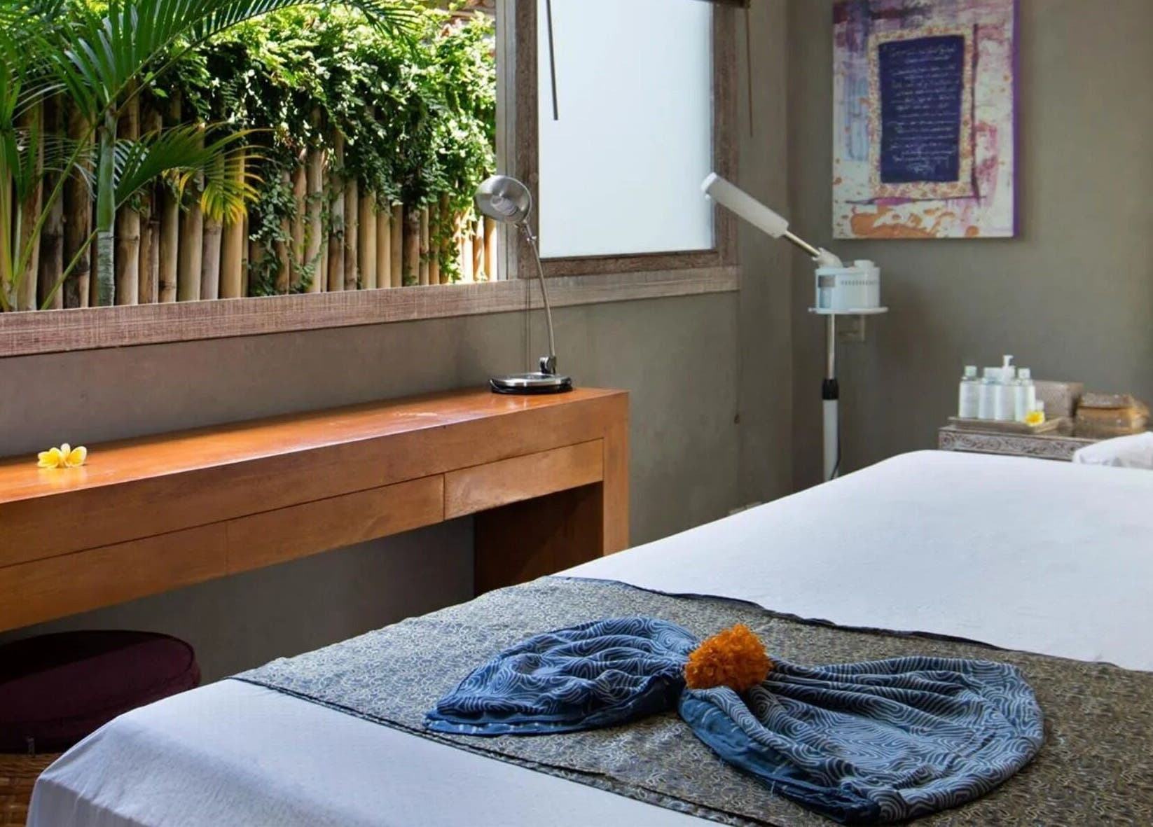 Peaceful massage room at Mudara Spa, Bali, Bali, ID, with a serene ambiance and lush plants.