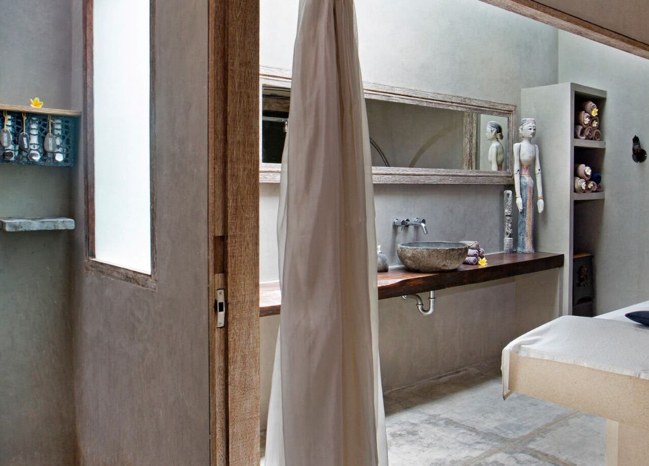 Serene spa room at Mudara Spa, Bali, Bali, ID with natural stone and calming decor.