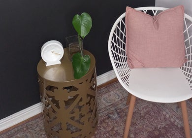 Elegant seating area at Sculpt & Go, Cape Town, Western Cape, ZA with stylish chair, pillow, and plant.
