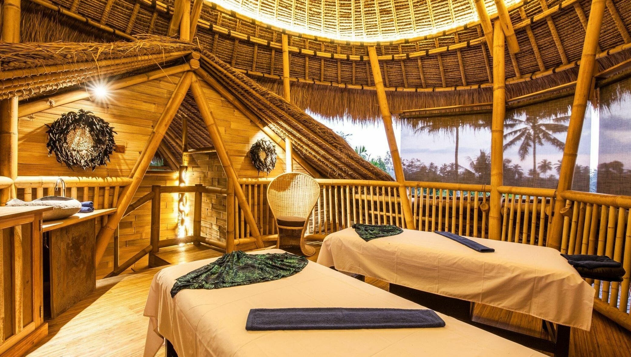 Serene bamboo spa room at Flying Bamboo Spa, Bali, Bali, ID with massage tables and natural decor.